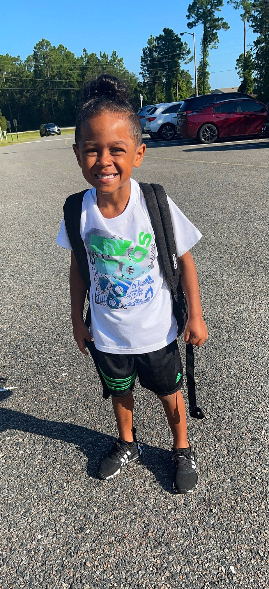 Malcolm is registered to the contest to win money with this photo: asphalt, automotive_tire, black, car, electric_blue, face, joy, knee, motor_vehicle, person, photograph, recreation, shorts, sleeve, smile, sportswear, standing, t_shirt, tire, vehicle_door