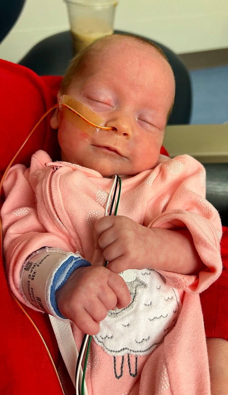 Ensley is registered to the contest to win money with this photo: baby, baby_products, baby_toddler_clothing, cheek, comfort, drinkware, face, finger, gesture, hand, happy, head, lip, mouth, nail, nose, person, pink, skin, thumb