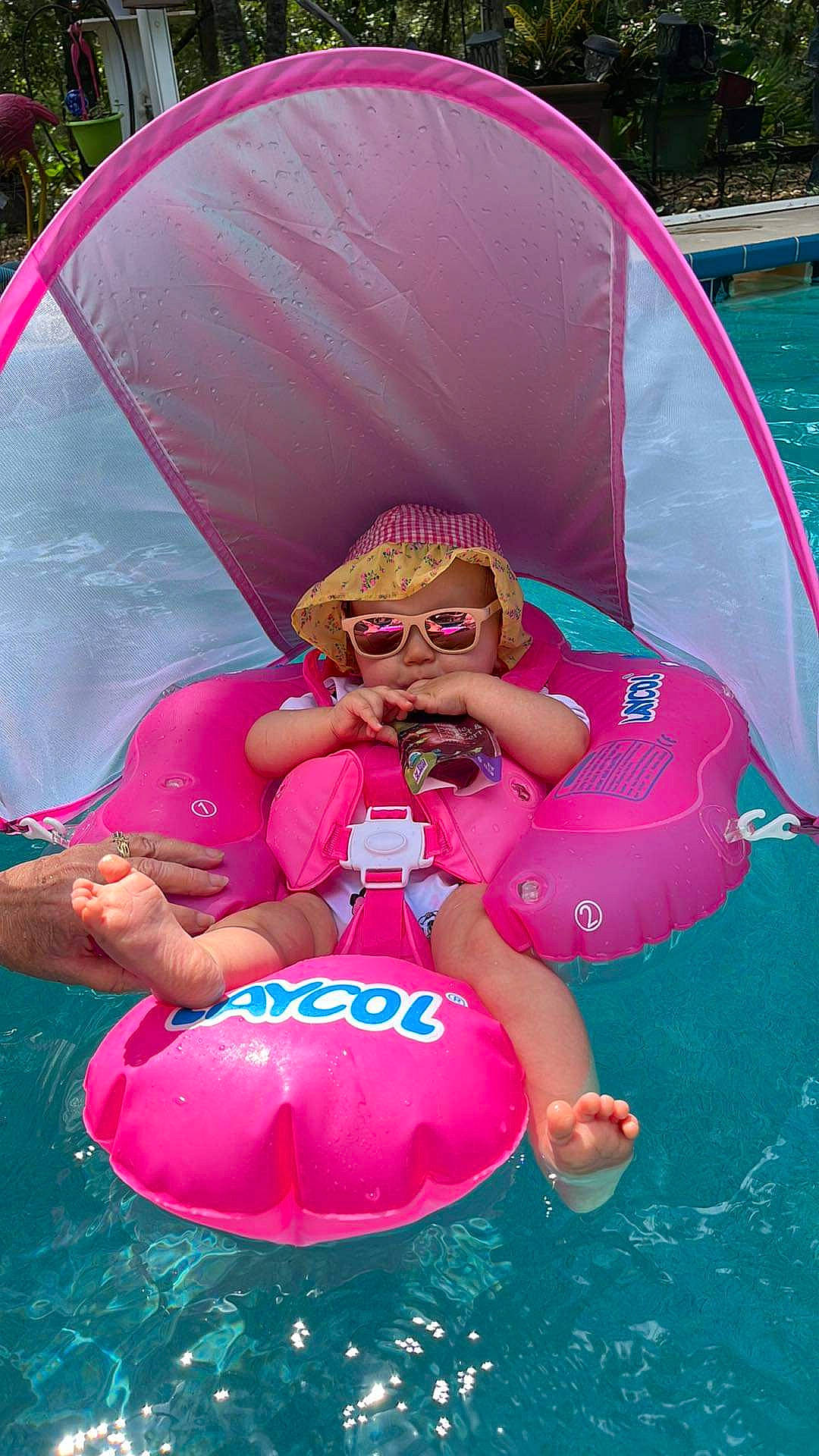 Ashlee is registered to the contest to win money with this photo: baby_float, baby_toddler_clothing, child, eyewear, fun, goggles, grass, green, happy, inflatable, leisure, magenta, outdoor_recreation, person, personal_protective_equipment, pink, recreation, red, sunglasses, toddler