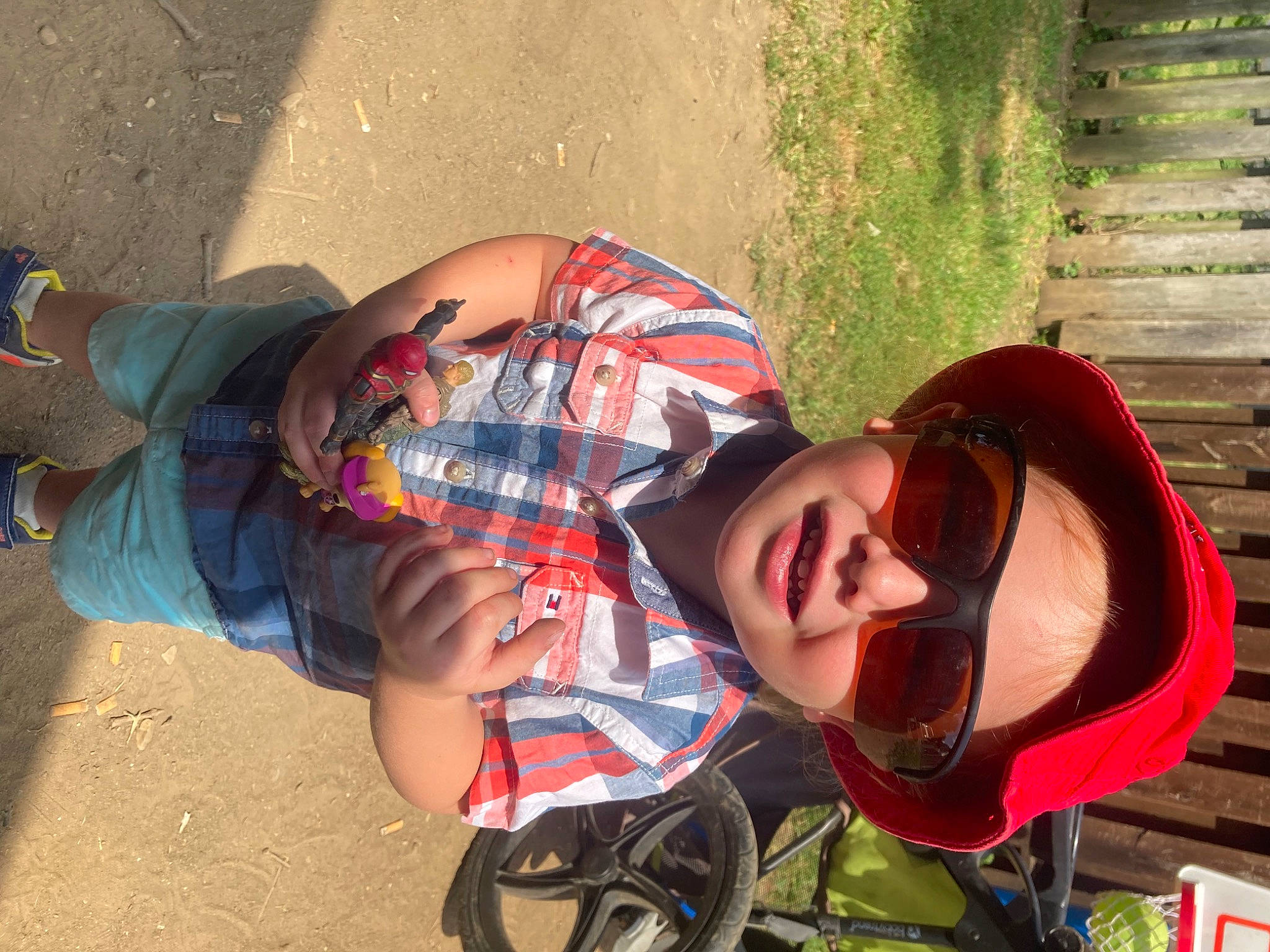 Kason joined the competition — help win amazing prizes! carmine, child, eyewear, fashion_accessory, fun, grass, happy, headwear, human_leg, leisure, pattern, people_in_nature, person, personal_protective_equipment, recreation, smile, soil, sunglasses, tire, toddler
