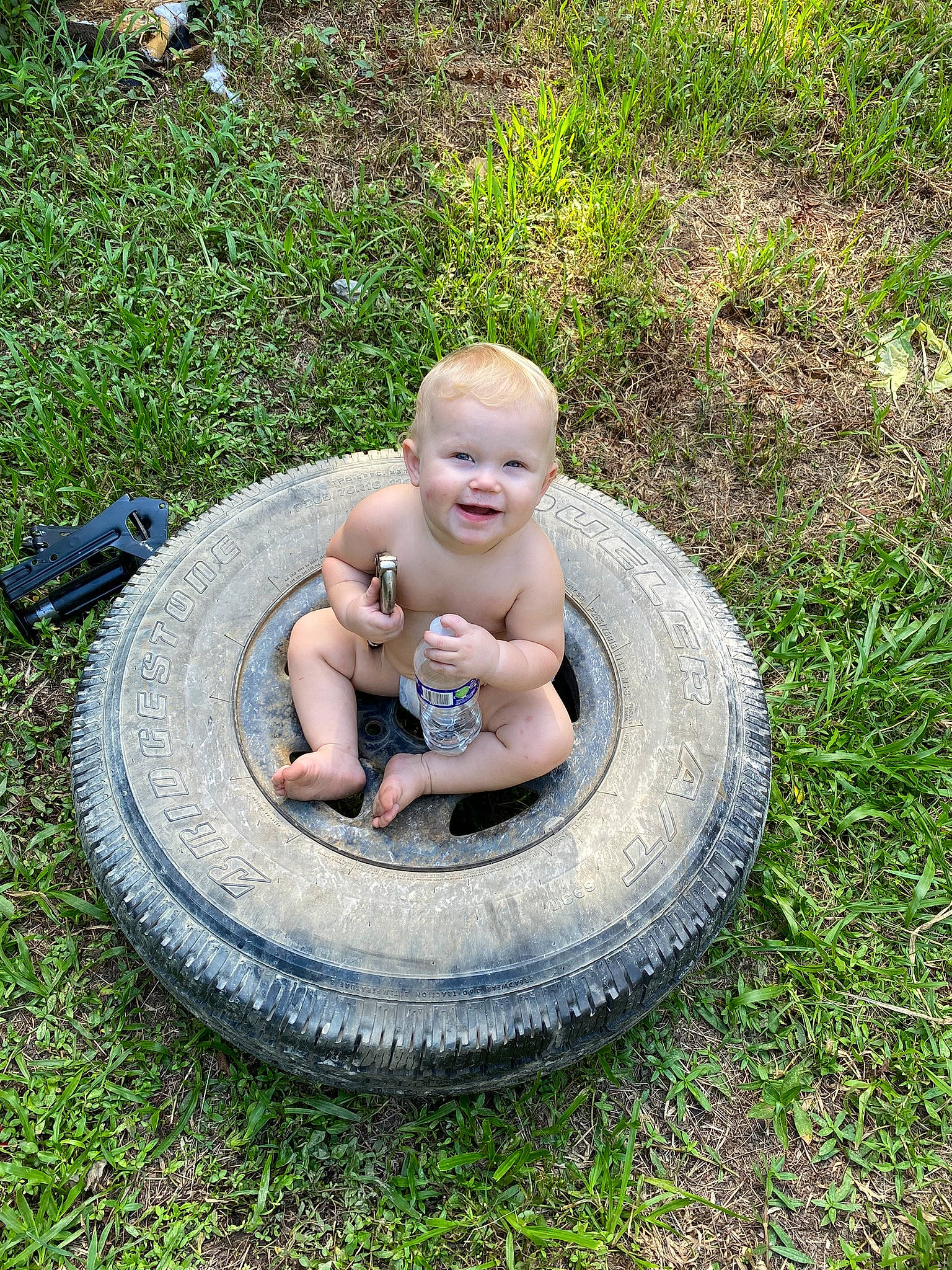 Brentley joined the competition — help win amazing prizes! automotive_tire, baby, child, circle, fun, garden, grass, grass_family, groundcover, joy, lawn, leisure, person, plant, sitting, smile, soil, synthetic_rubber, toddler, tread