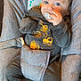 baby, infant, pacifier, baby_seat, grey_clothing, blue_eyes, cozy, cute, relaxed, indoors, child, soft_fabric, portrait, young, sitting, baby_outfit, cushion, small_hands, looking_at_camera, casual
