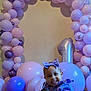 arch, baby, balloons, birthday, bow, celebration, child, cute, decorations, dress, floor, happy, indoors, number_one, party, pink, purple, smile, toddler, tongue_out