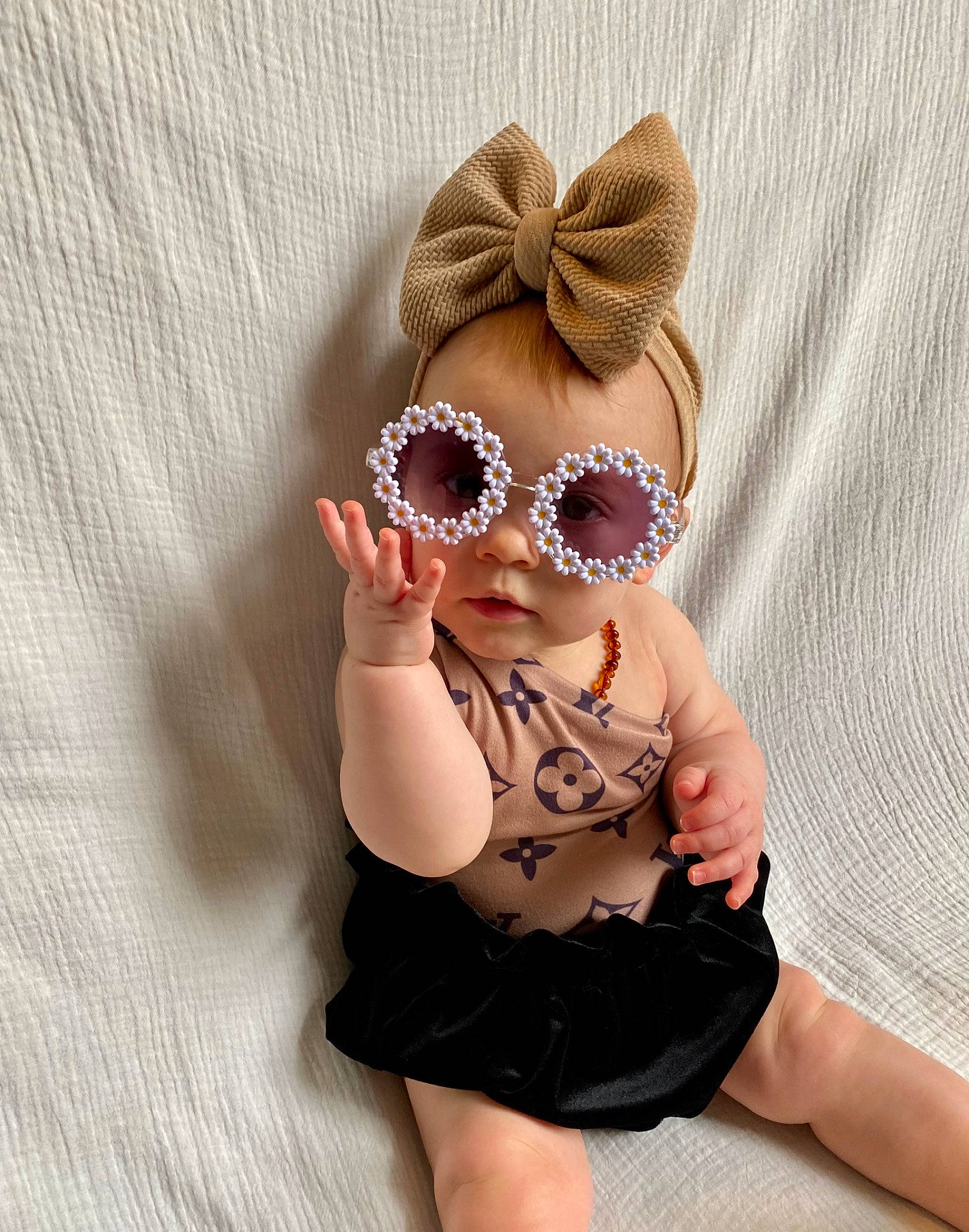 Everlee is registered to the contest to win money with this photo: baby, baby_toddler_clothing, cap, costume_hat, eyewear, face, fawn, finger, goggles, head, headband, headpiece, human_body, insect, jewellery, person, pollinator, sleeve, sun_hat, textile