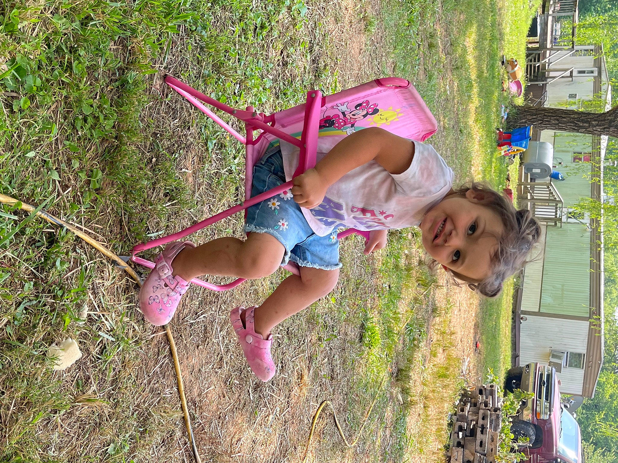 Raven is registered to the contest to win money with this photo: child, city, fun, grass, happy, joy, landscape, leisure, magenta, outdoor_play_equipment, people_in_nature, person, plant, play, recreation, shorts, spring, t_shirt, toddler, tree