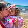 Mélody participe au concours pour gagner de l'argent avec cette photo : child, toddler, woman, beach, ocean, sand, towel, hat, kiss, love, affection, sunny, water, sky, summer, portrait, outdoor, vacation, family, tattoo
