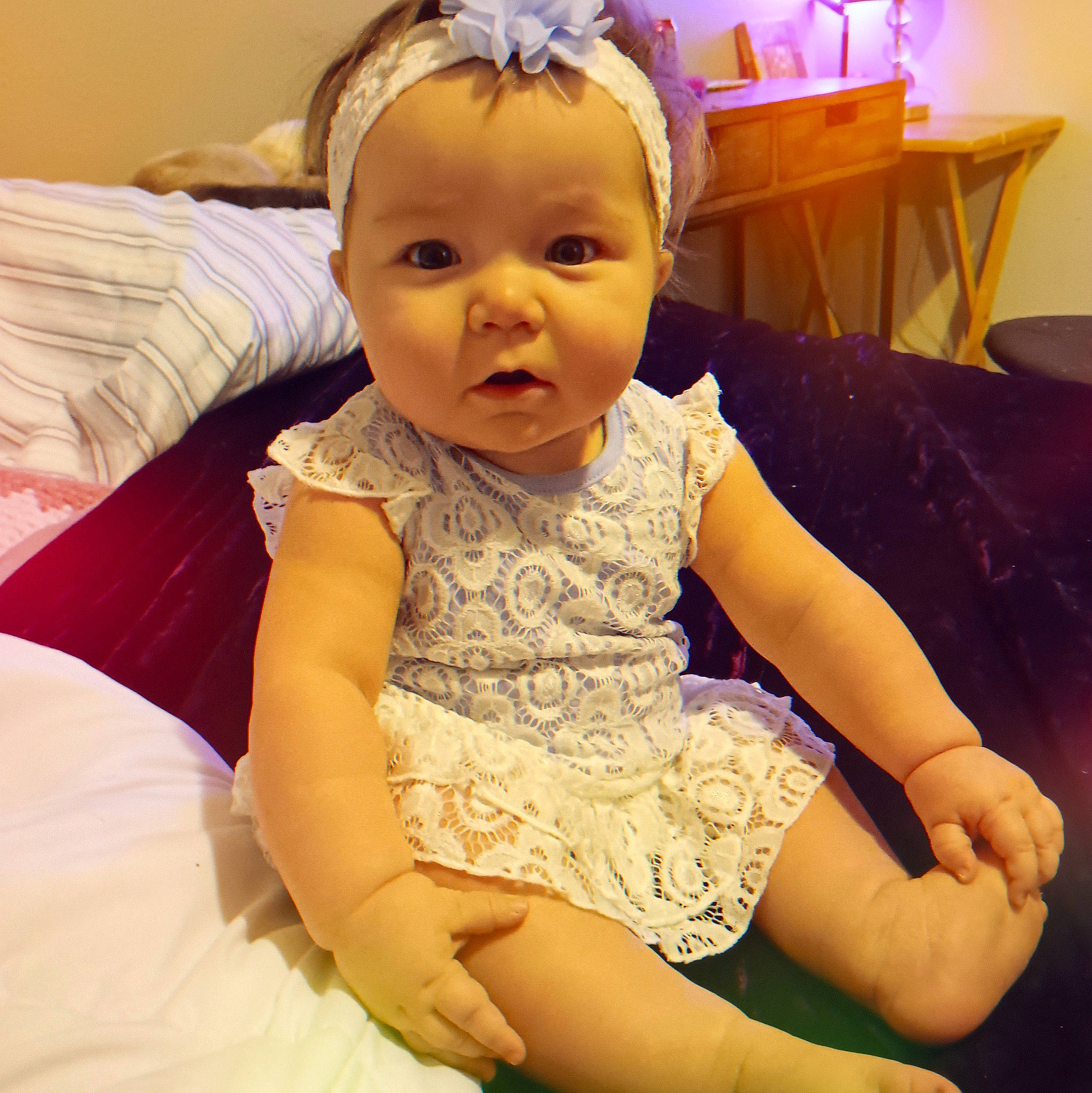 Bailey is registered to the contest to win money with this photo: baby, baby_toddler_clothing, cheek, child, comfort, eyelash, facial_expression, finger, fun, happy, head, headpiece, human_leg, person, pink, sitting, skin, sleeve, smile, thigh