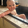baby, bathtub, water, child, smile, blue_eyes, skin, wet_hair, arm, relaxing, natural_light, bathroom, wood, edge, infant, cute, portrait, happy, young_child, indoors