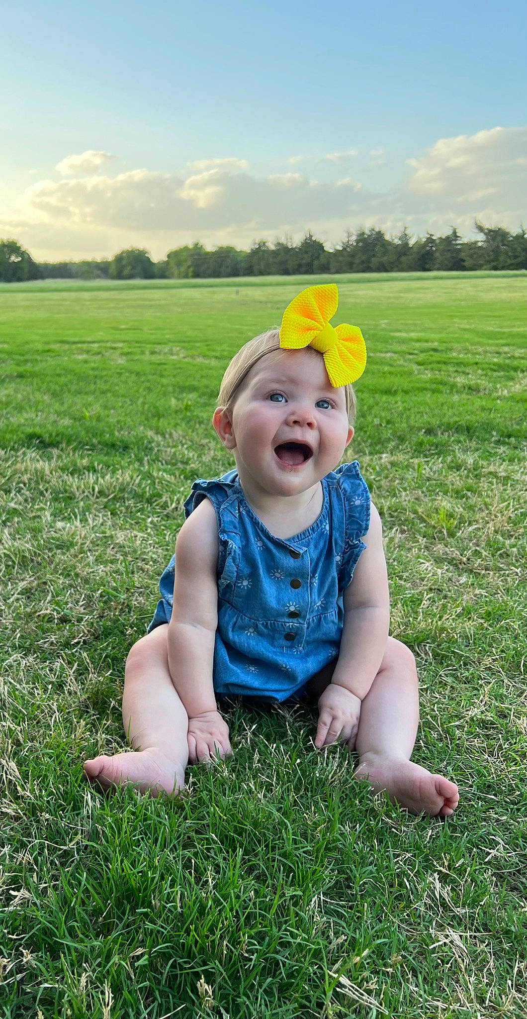 Landry joined the competition — help win amazing prizes! baby, baby_toddler_clothing, botany, cloud, flower, grass, grassland, happy, hat, headwear, natural_environment, people_in_nature, person, plant, sky, smile, standing, sun_hat, sunlight, toddler