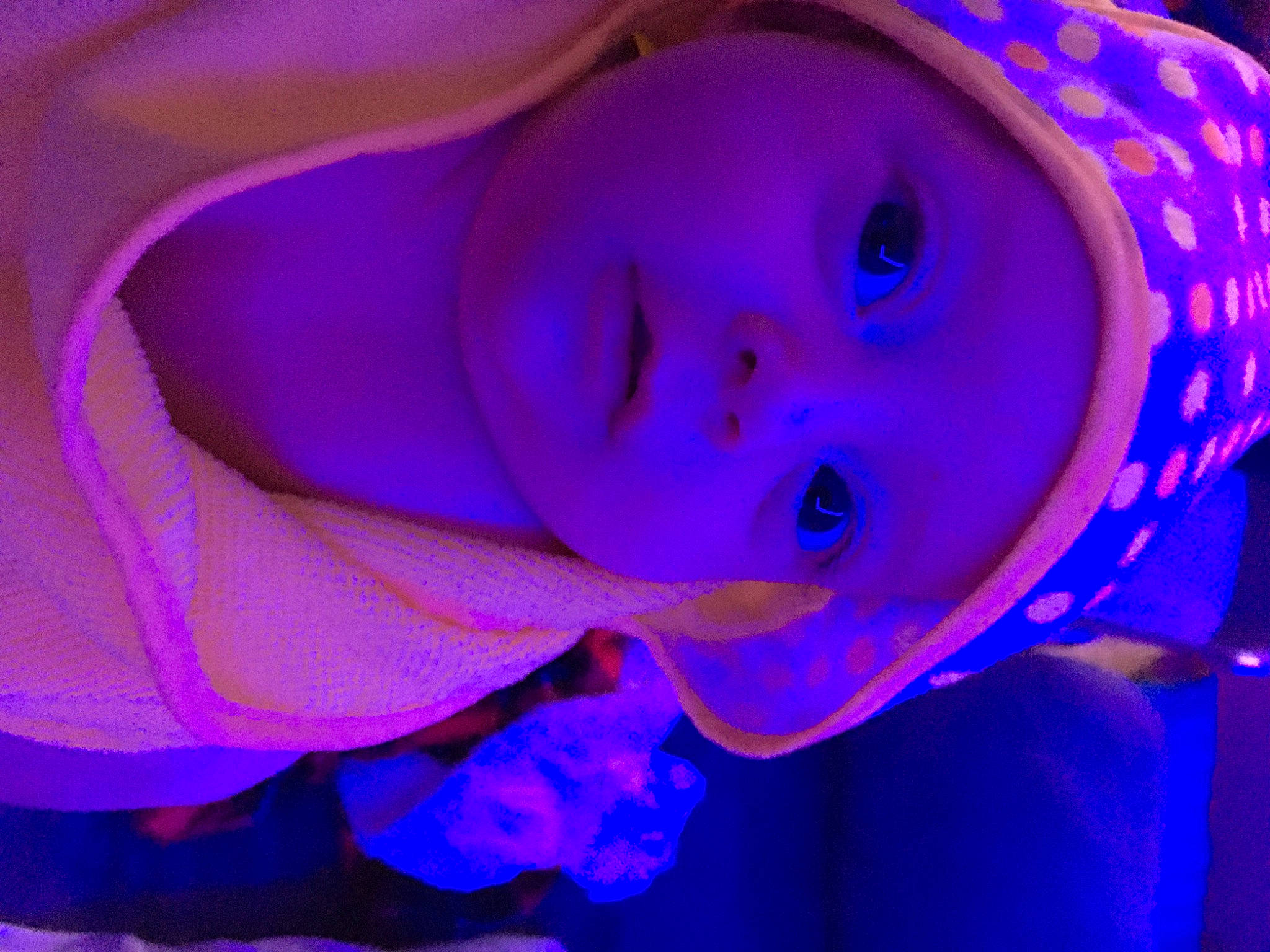 Kaiser is registered to the contest to win money with this photo: azure, baby, child, close_up, electric_blue, event, eyebrow, fashion_accessory, fun, headwear, iris, magenta, person, personal_protective_equipment, petal, pink, purple, sky, smile, toddler