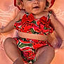 Joy participe au concours pour gagner de l'argent avec cette photo : baby, infant, smiling, watermelon_outfit, hat, pink_blanket, cute, happy, child, lying_down, summer_clothes, chubby_legs, adorable, playful, person, portrait, closeup, skin, face, headwear