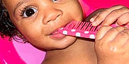 Niema is registered to the contest to win money with this photo: baby, child, tub, pink, comb, wet_hair, curly_hair, hands, face, large_eyes, bath, water, skin, chewing, cute, indoors, paper_towel, background, playful, closeup