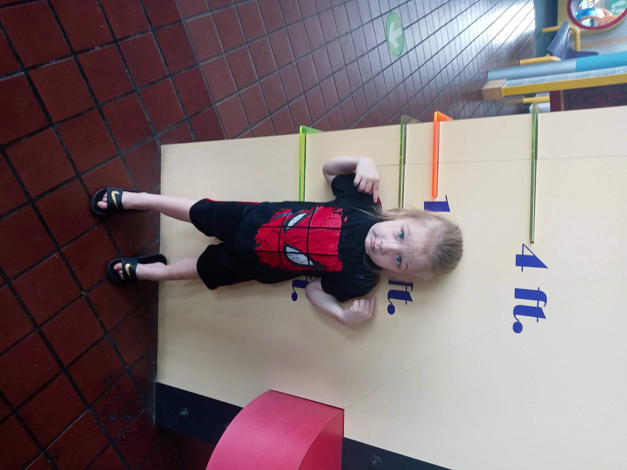 Gabriel is registered to the contest to win money with this photo: ball, carmine, fictional_character, flooring, fun, human_leg, knee, magenta, pattern, person, red, room, shorts, sock, sportswear, thigh, toddler