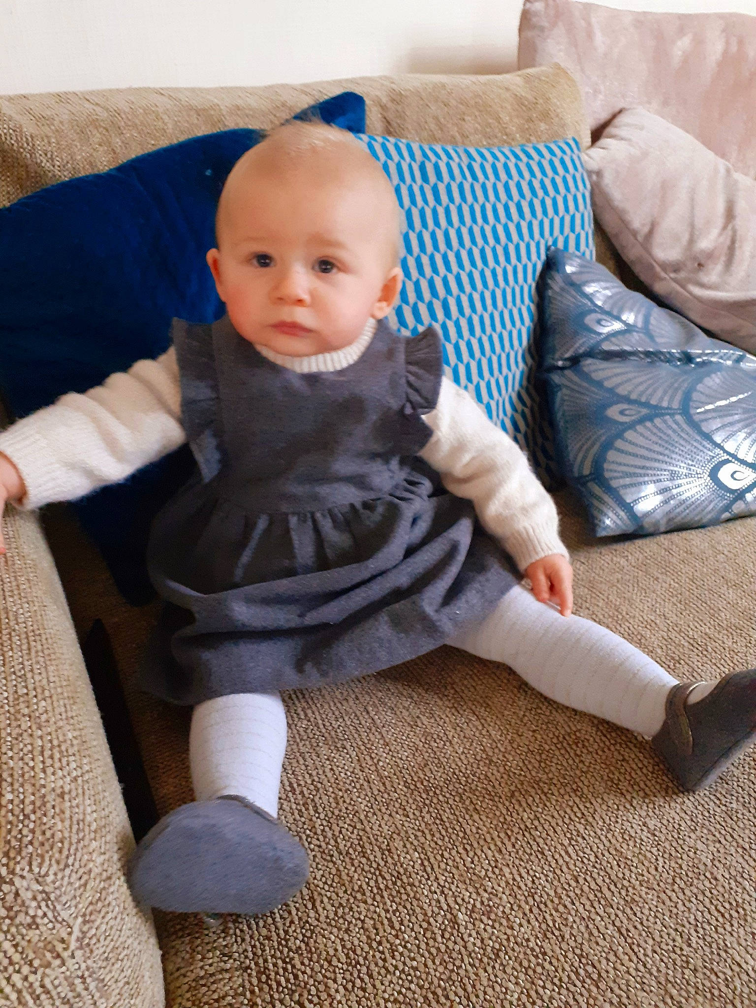 Aëla participe au concours pour gagner de l'argent avec cette photo : ankle, baby, baby_toddler_clothing, child, comfort, couch, cushion, ear, home_accessories, human_body, linens, living_room, nose, person, pillow, sitting, sock, throw_pillow, toddler, wool