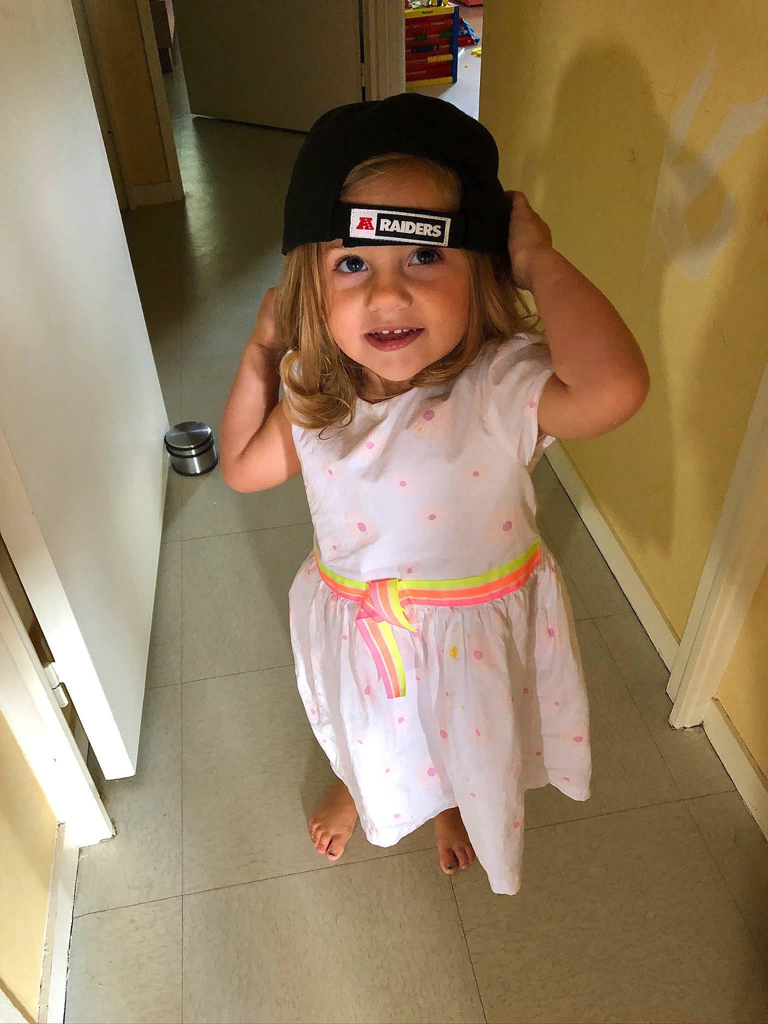 Julia Fouche a rejoint le concours — aidez-le/la à gagner de superbes lots ! baby_toddler_clothing, baseball_cap, cap, eyewear, floor, flooring, fun, happy, human_leg, joy, knee, person, pink, skin, sleeve, sock, sunglasses, t_shirt, thigh, toddler