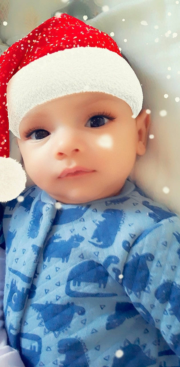 Emrys is registered to the contest to win money with this photo: baby, blue, cheek, child, doll, eye, face, forehead, head, headgear, headwear, lip, person, pink, skin, toddler, toy