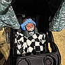 Paul is registered to the contest to win money with this photo: baby, black_and_white, blanket, canopy, checkered, child, clothing, headphones, infant, leaf_pattern, outdoor, pacifier, person, resting, seat_belt, shadow, sleeping, stroller, sunlight, wheel