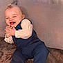 Milann participe au concours pour gagner de l'argent avec cette photo : baby, child, clothing, couch, cute, expression, face, funny, furniture, hands, happy, indoors, laughing, pants, person, portrait, sitting, smiling, socks, vest