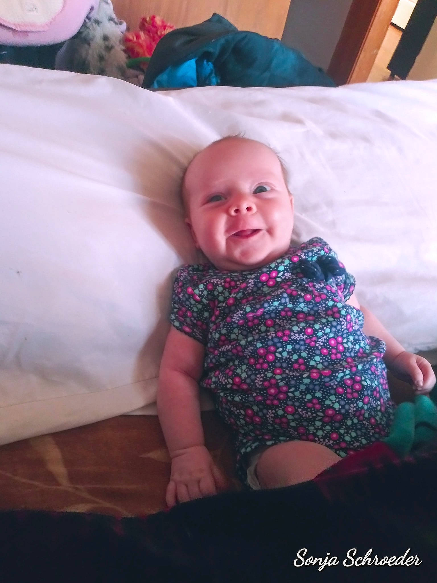 Wyllow is registered to the contest to win money with this photo: baby, cheek, child, face, family, furniture, happy, head, people, person, photograph, photography, pink, room, sitting, skin, smile, toddler, vacation