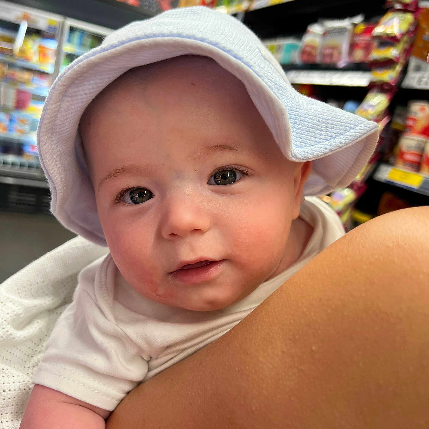Lucas joined the competition — help win amazing prizes! aisle, baby, child, closeup, cute, expression, face, food, grocery_store, hat, headwear, holding, indoor, infant, person, retail, shelf, shopping, skin, white_clothing