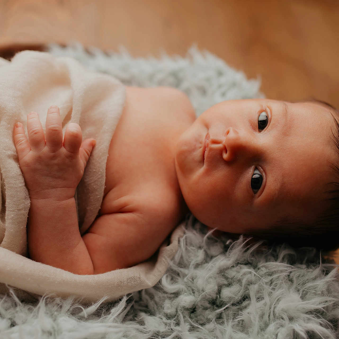 Lyam joined the competition — help win amazing prizes! newborn, baby, infant, wrapped, cloth, blanket, soft_texture, lying_down, curious_look, skin, face, hand, fingers, indoors, portrait, cute, toddler, child, sleepy, resting