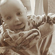 Amelia is registered to the contest to win money with this photo: baby, child, jumper, smile, face, indoor, vintage, sepia, furniture, chair, carpet, clothing, person, blur, nostalgia, play, babywear, hanging, happy, infant