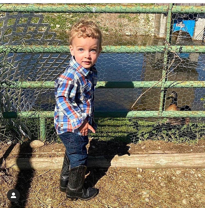 Ray is registered to the contest to win money with this photo: child, garden, grass, jeans, person, plant, play, smile, soil, toddler, tree, wall