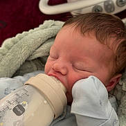 Rowan is registered to the contest to win money with this photo: baby, bottle, feeding, blanket, mittens, infant, sleeping, cozy, blue_outfit, cute, newborn, soft, closeup, peaceful, indoors, person, child, mamm_bottle, hand, face