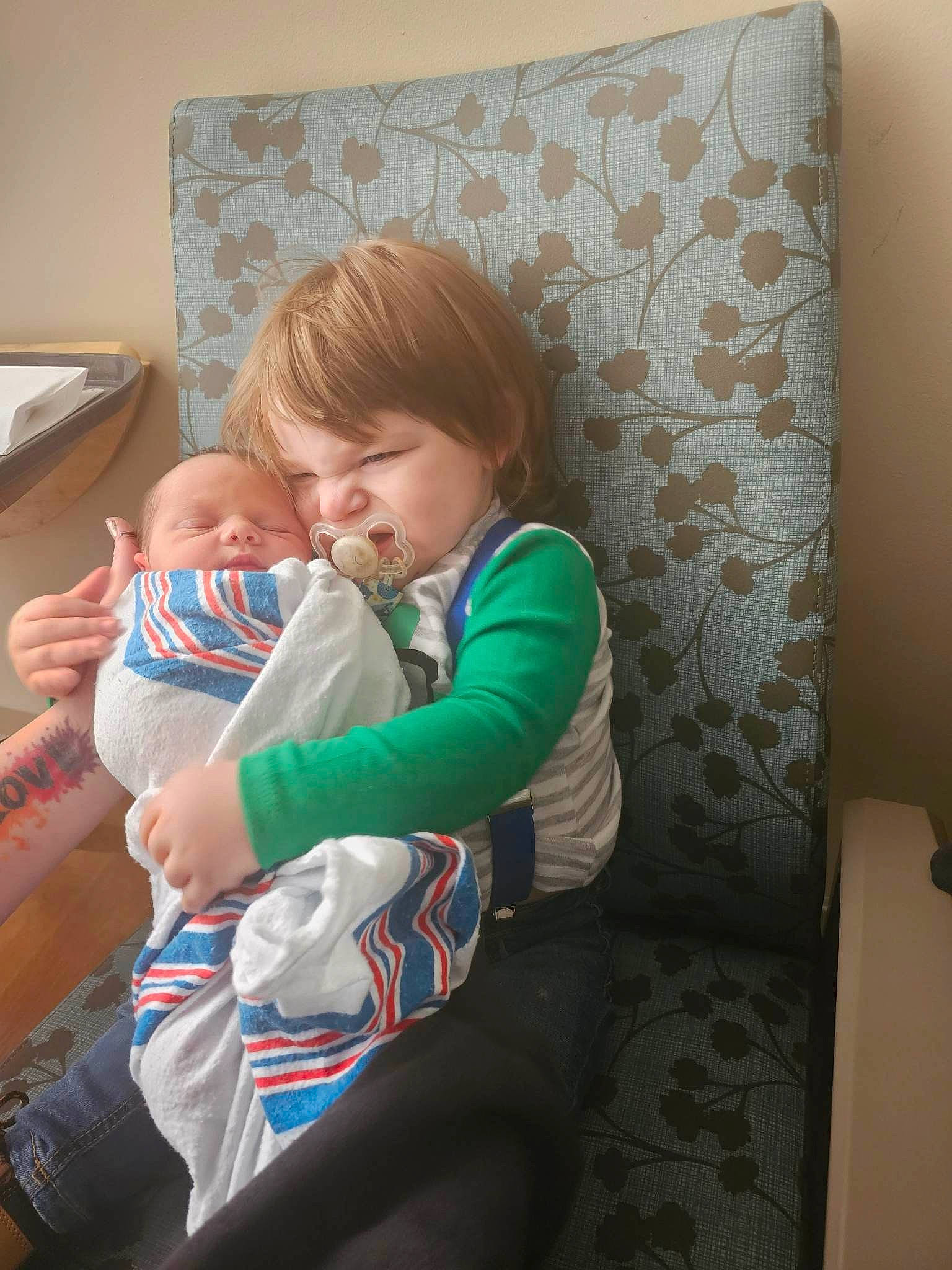 Auston joined the competition — help win amazing prizes! baby, baby_toddler_clothing, chair, child, comfort, couch, elbow, furniture, human_leg, knee, lap, linens, nail, person, pillow, room, sitting, sock, t_shirt, thigh