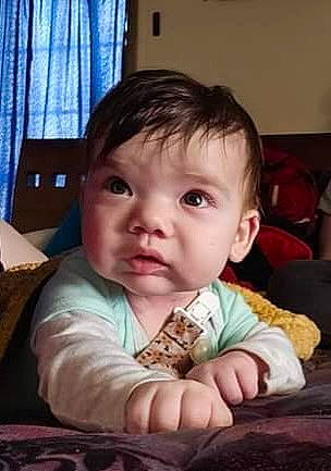 Alex is registered to the contest to win money with this photo: baby, baby_toddler_clothing, cheek, child, comfort, couch, curtain, fun, iris, nose, person, room, sitting, skin, thumb, toddler, window, window_treatment, wood