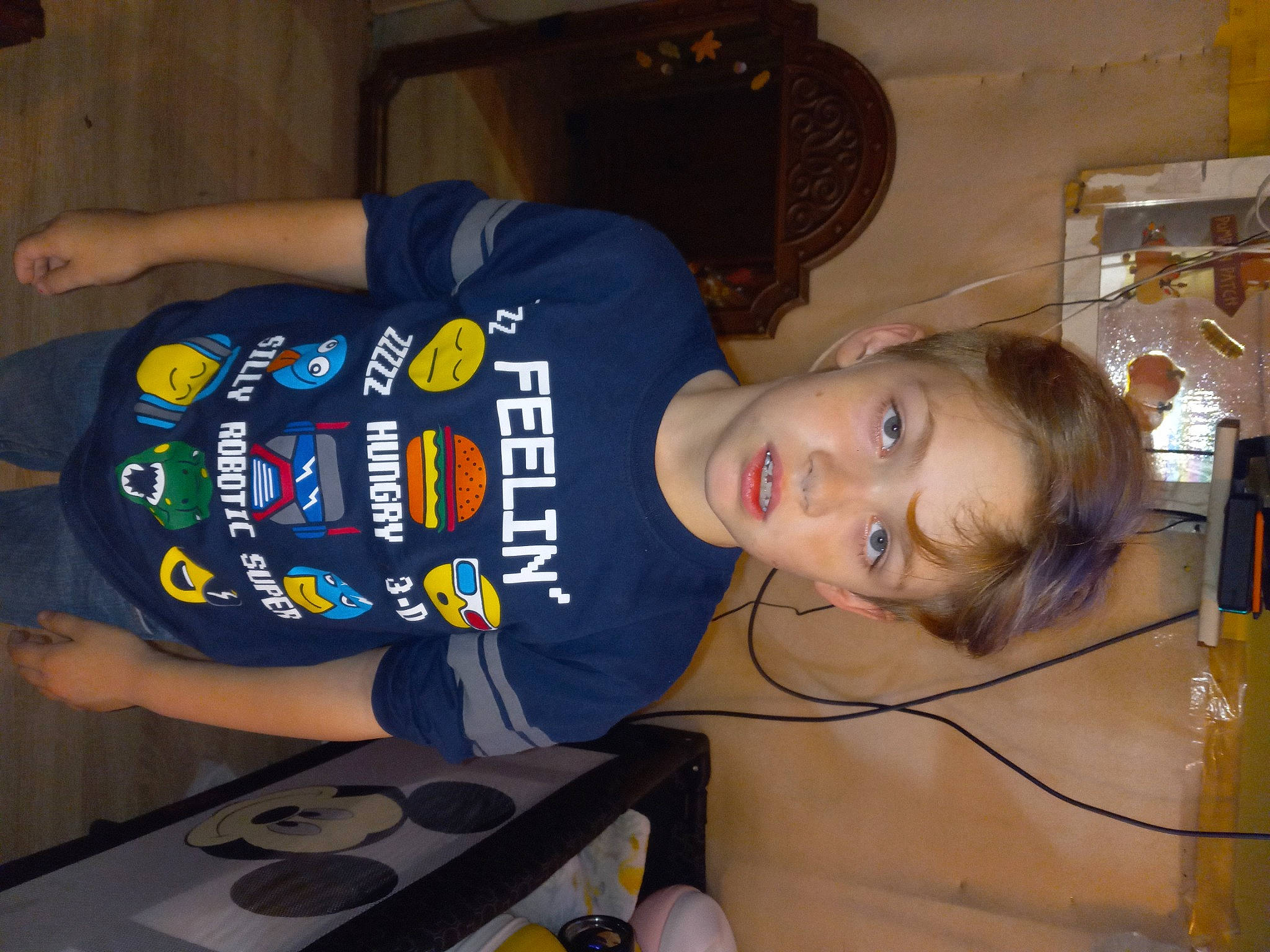 Charlie is registered to the contest to win money with this photo: child, elbow, electric_blue, finger, fun, headgear, person, personal_protective_equipment, room, t_shirt, toddler, wrist