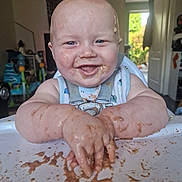 Mason joined the competition — help win amazing prizes! baby, high_chair, messy, chocolate, food, smiling, happy, indoor, child, face, arms, hands, pudding, feeding_time, home, daylight, toy, clothing, playful, infant