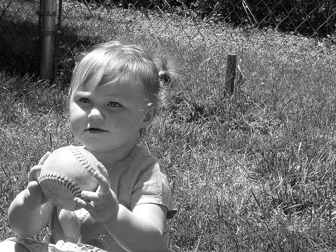 Haylee Ray is registered to the contest to win money with this photo: ball, black, black_and_white, child, fruit, fun, grass, grass_family, grassland, happy, monochrome, monochrome_photography, people_in_nature, person, plant, sitting, smile, sports_equipment, stock_photography, style