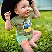 Haze joined the competition — help win amazing prizes! animal_print, baby, child, cute, feet, grass, green, hands, happy, hat, nature, outdoor, playful, portrait, shirt, shorts, sitting, smiling, sunlight, toddler