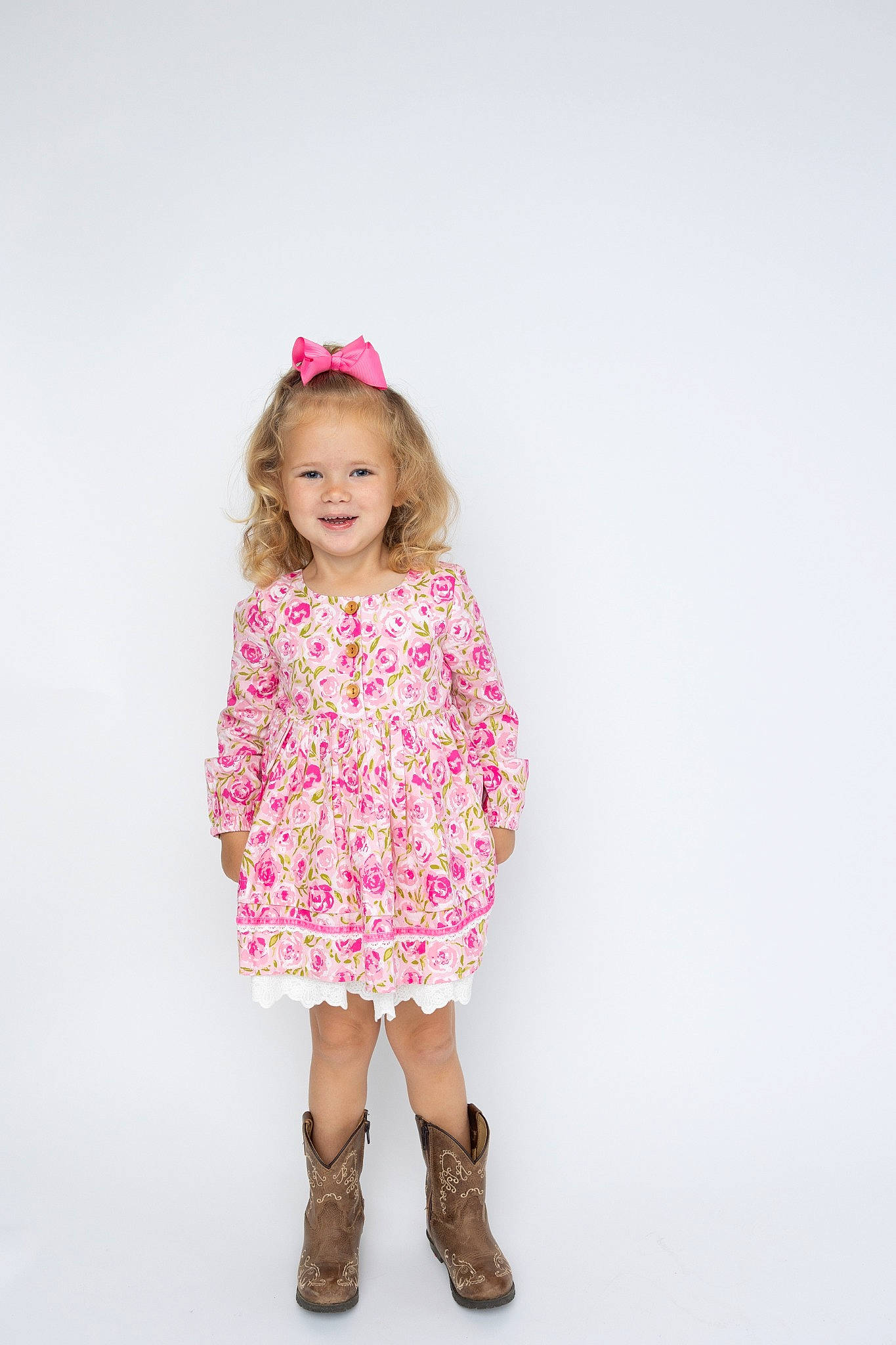 Callie is registered to the contest to win money with this photo: baby_toddler_clothing, collar, day_dress, dress, eye, face, fashion_design, gesture, happy, head, human_body, joy, lip, magenta, one_piece_garment, pattern, person, pink, sleeve, smile