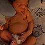 Jordyn Evans is registered to the contest to win money with this photo: baby, newborn, sleeping, diaper, neck_pillow, blanket, infant, cute, peaceful, soft, rest, child, cozy, comfort, skin, hand, foot, face, indoors, lying_down