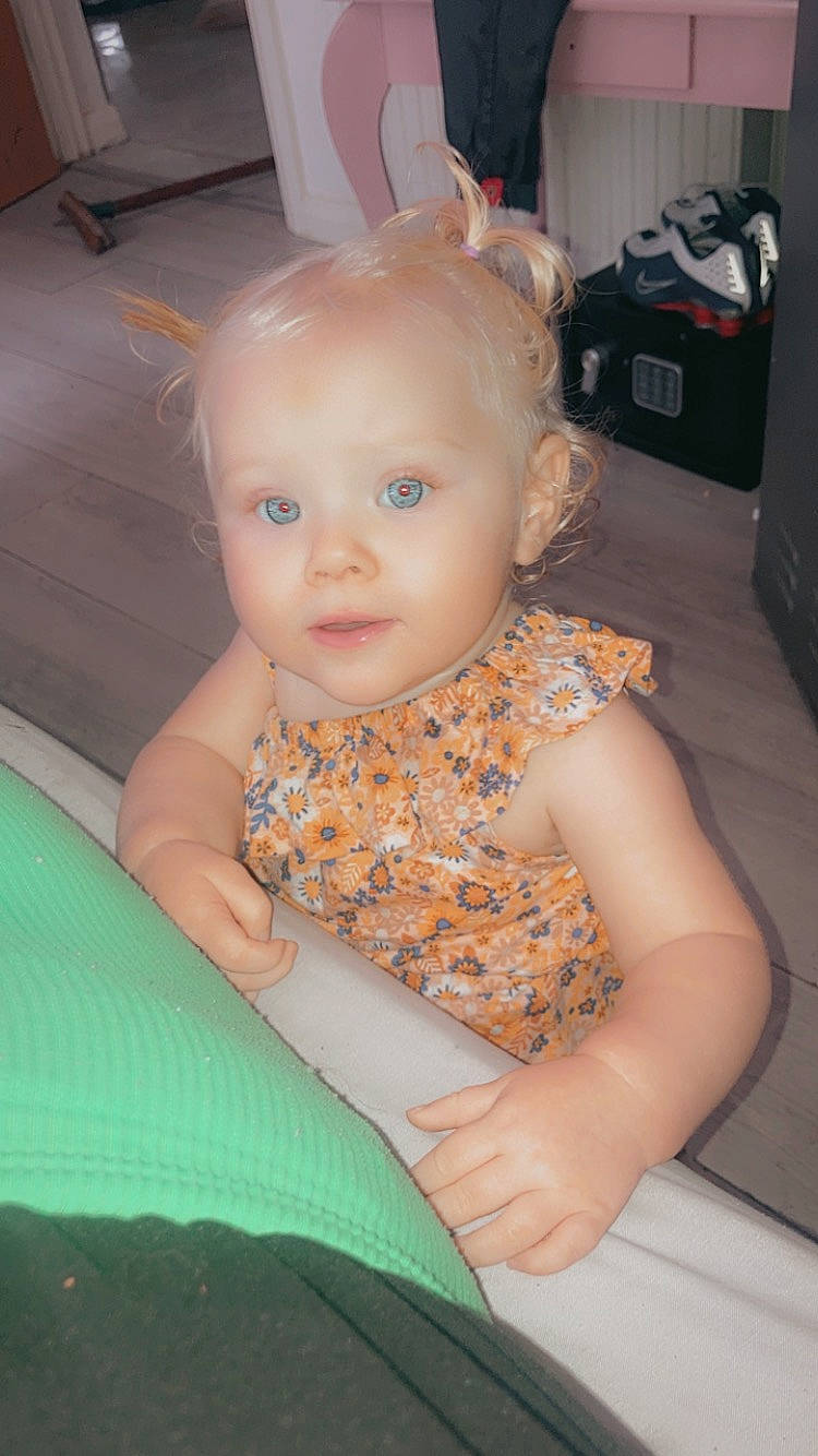 Amelia-rose is registered to the contest to win money with this photo: baby, baby_toddler_clothing, chair, cheek, chest, child, comfort, eye, flooring, fun, grass, head, human_body, iris, mouth, nose, person, room, sitting, skin