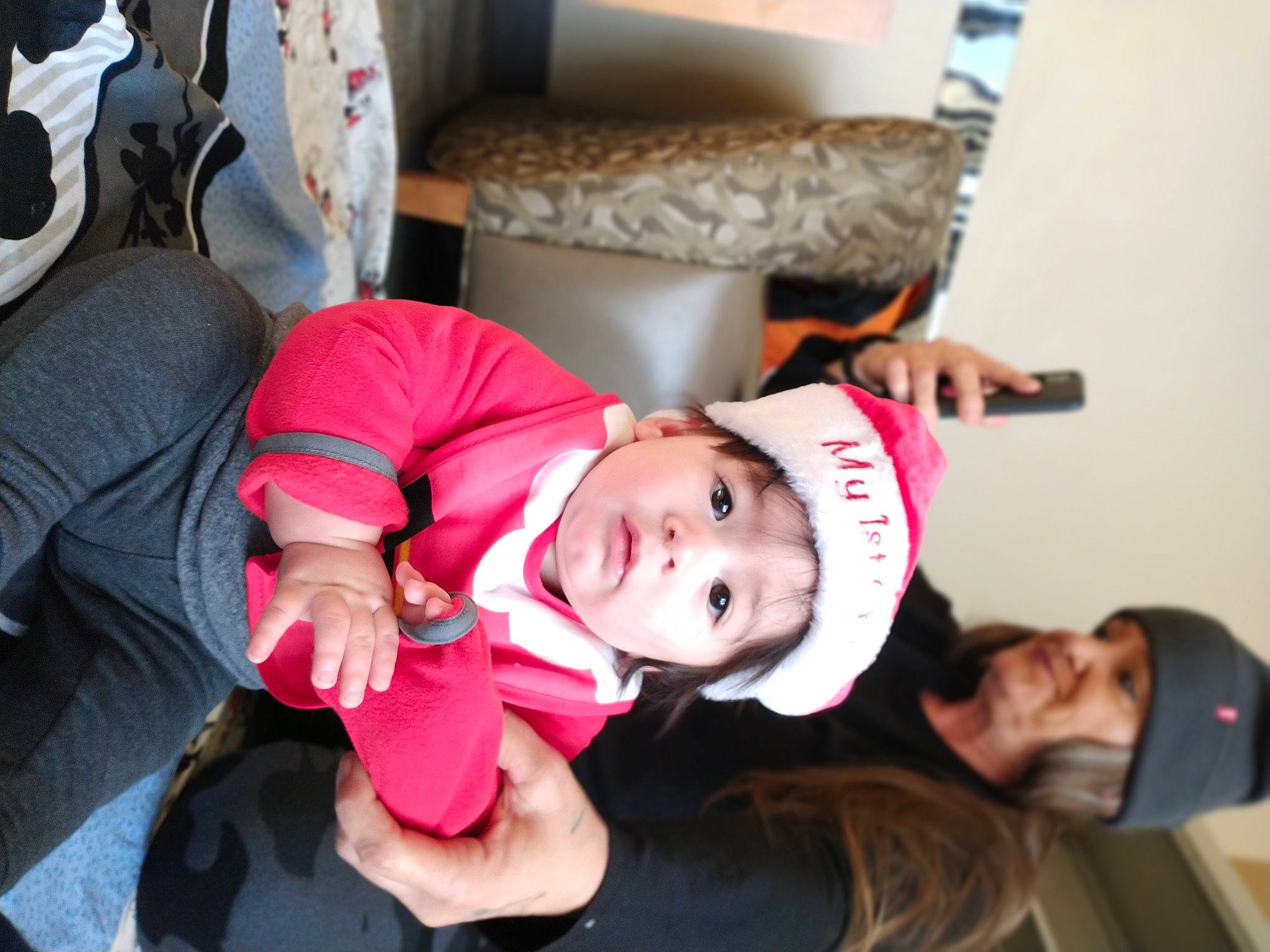 Marc is registered to the contest to win money with this photo: baby, baby_products, baby_toddler_clothing, carmine, child, comfort, costume, event, fun, happy, hat, headwear, joy, lap, person, room, sitting, toddler, tree