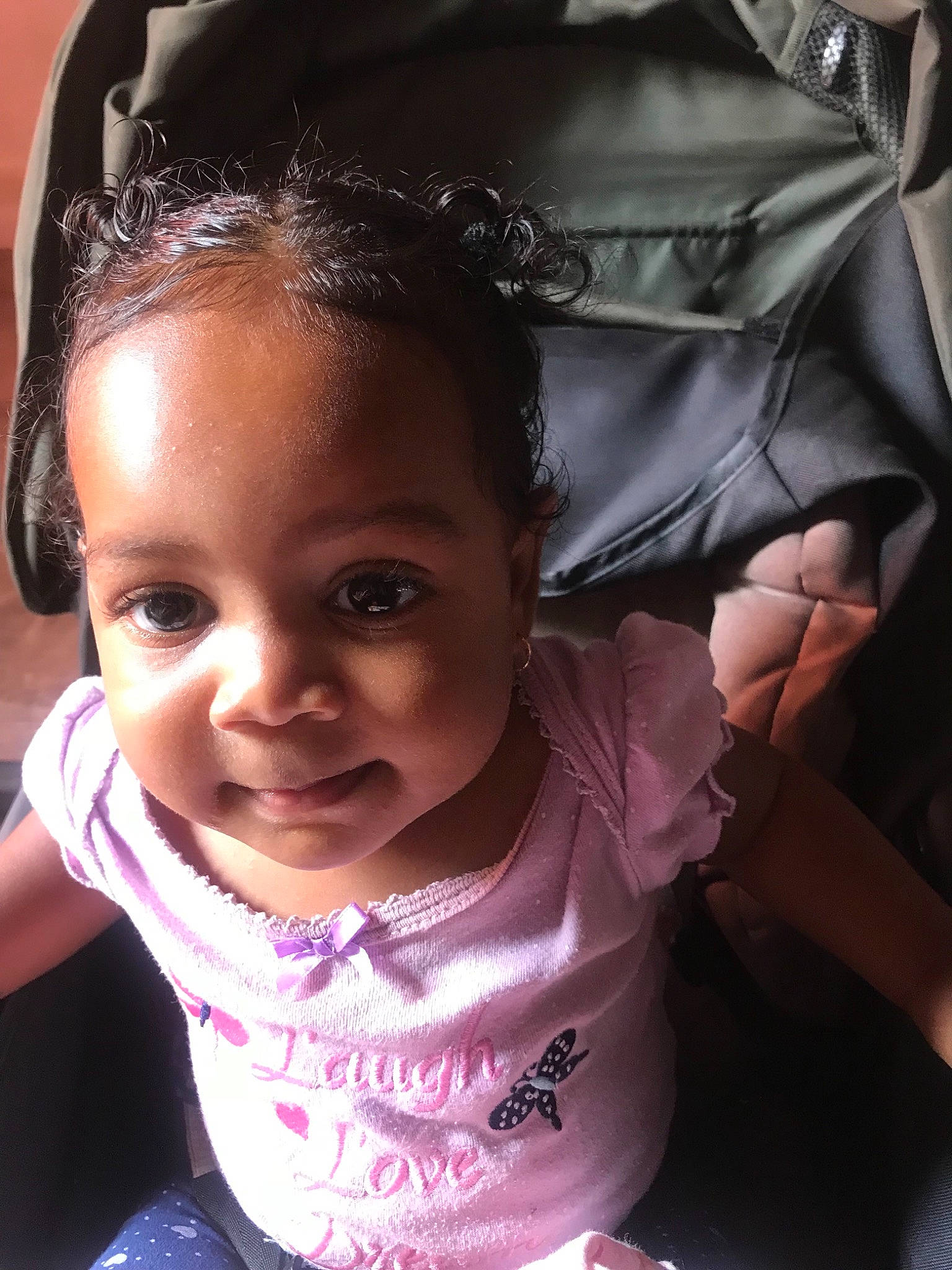 Nalya participe au concours pour gagner de l'argent avec cette photo : black_hair, cheek, child, ear, eye, face, forehead, girl, hairstyle, head, infant, joy, person, pink, product, skin, smile, toddler