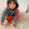 Alijah joined the competition — help win amazing prizes! toddler, child, hoodie, gray_clothing, green_pants, barefoot, red_seat, plastic_seat, curious_expression, looking_up, young_child, indoor, concrete_floor, textured_wall, candid, playful, sitting, portrait, casual_clothing, small_hands