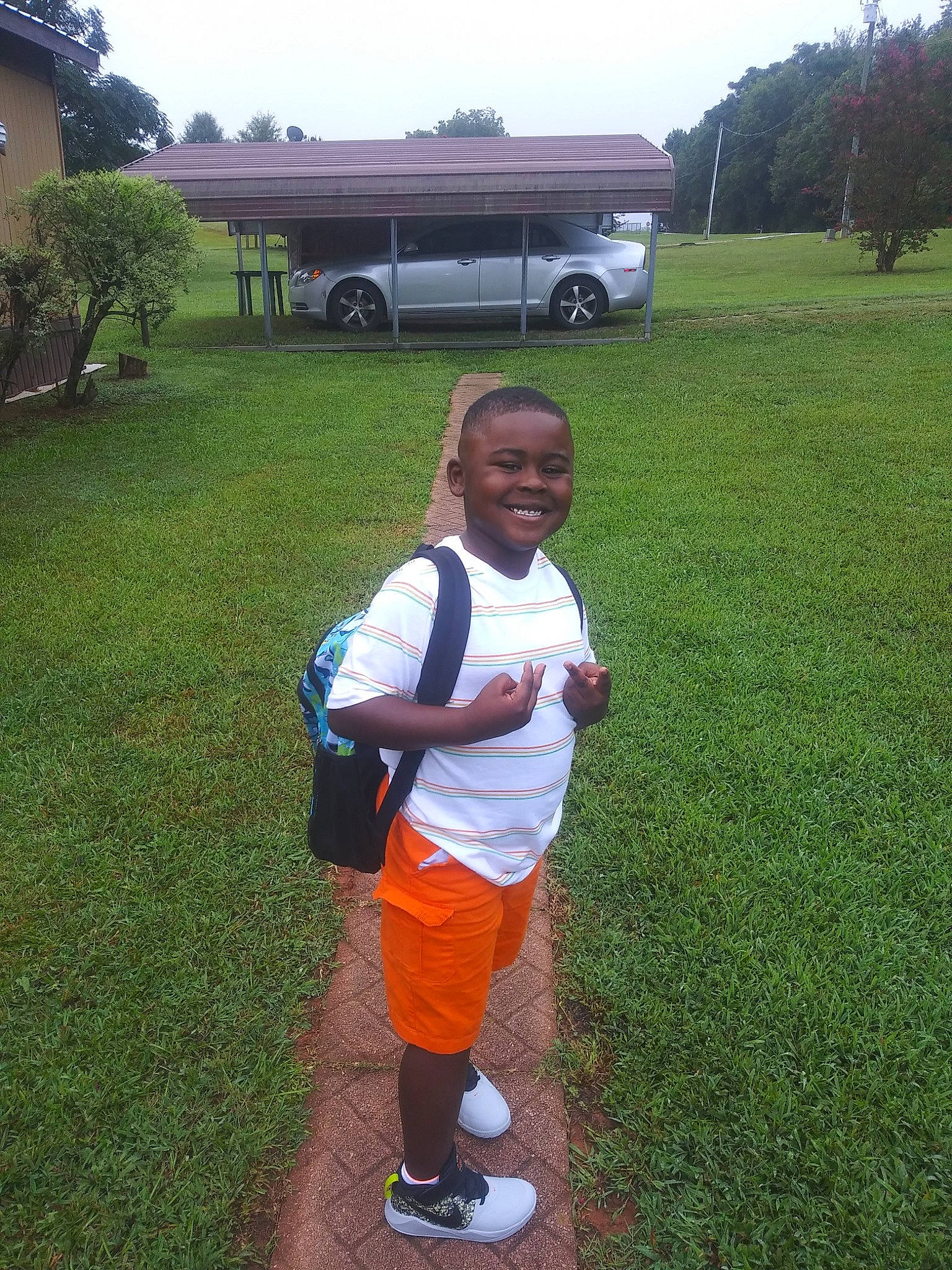 Anthony joined the competition — help win amazing prizes! automotive_exterior, grass, grassland, happy, joy, landscape, leaf, leisure, light, motor_vehicle, nature, person, plant, recreation, shorts, sky, smile, t_shirt, tire, tree