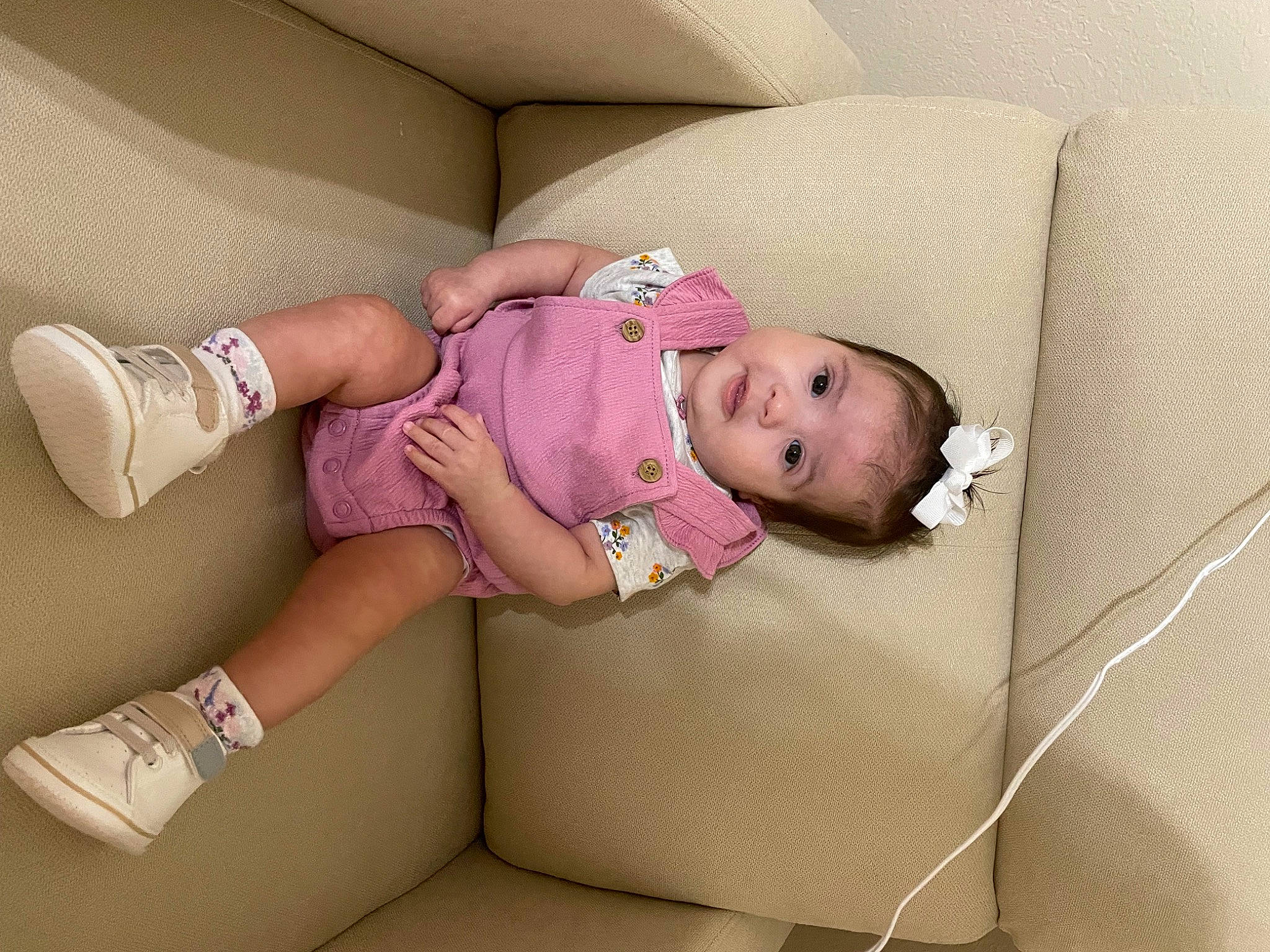 Viviana is registered to the contest to win money with this photo: arm, baby, baby_sleeping, baby_toddler_clothing, child, comfort, couch, foot, human_leg, knee, linens, pattern, person, pink, room, skin, sleeve, sock, textile, thigh
