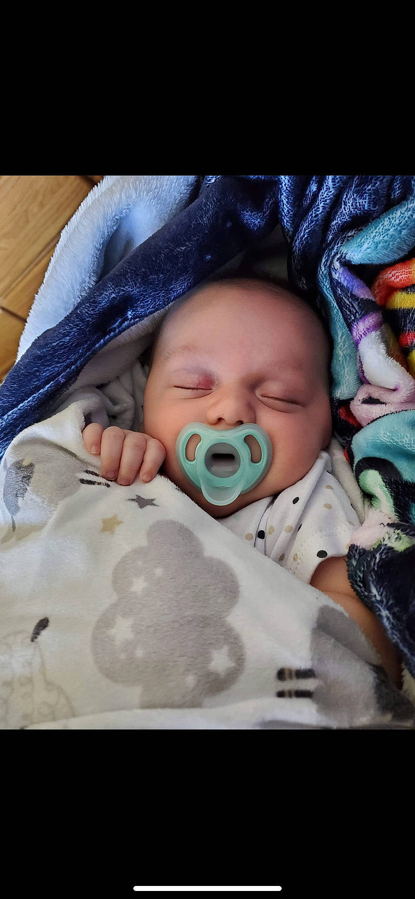 Jaxxen is registered to the contest to win money with this photo: baby, baby_products, baby_toddler_clothing, cheek, child, chin, comfort, event, eye, face, facial_expression, happy, head, iris, linens, mouth, nose, person, skin, textile