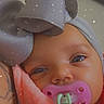 baby, infant, child, portrait, close_up, face, eyes, pacifier, bow, headband, blanket, pink_blanket, gray_bow, sparkle_filter, indoor, cozy, closeup_photography, smiling, cuddled, colorful