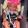 baby, infant, child, car_seat, pink_bow, headband, pacifier, toy, floral_pattern, sitting, portrait, face, smiling, indoors, safety_harness, baby_clothing, shoes, feet, close_up, colorful