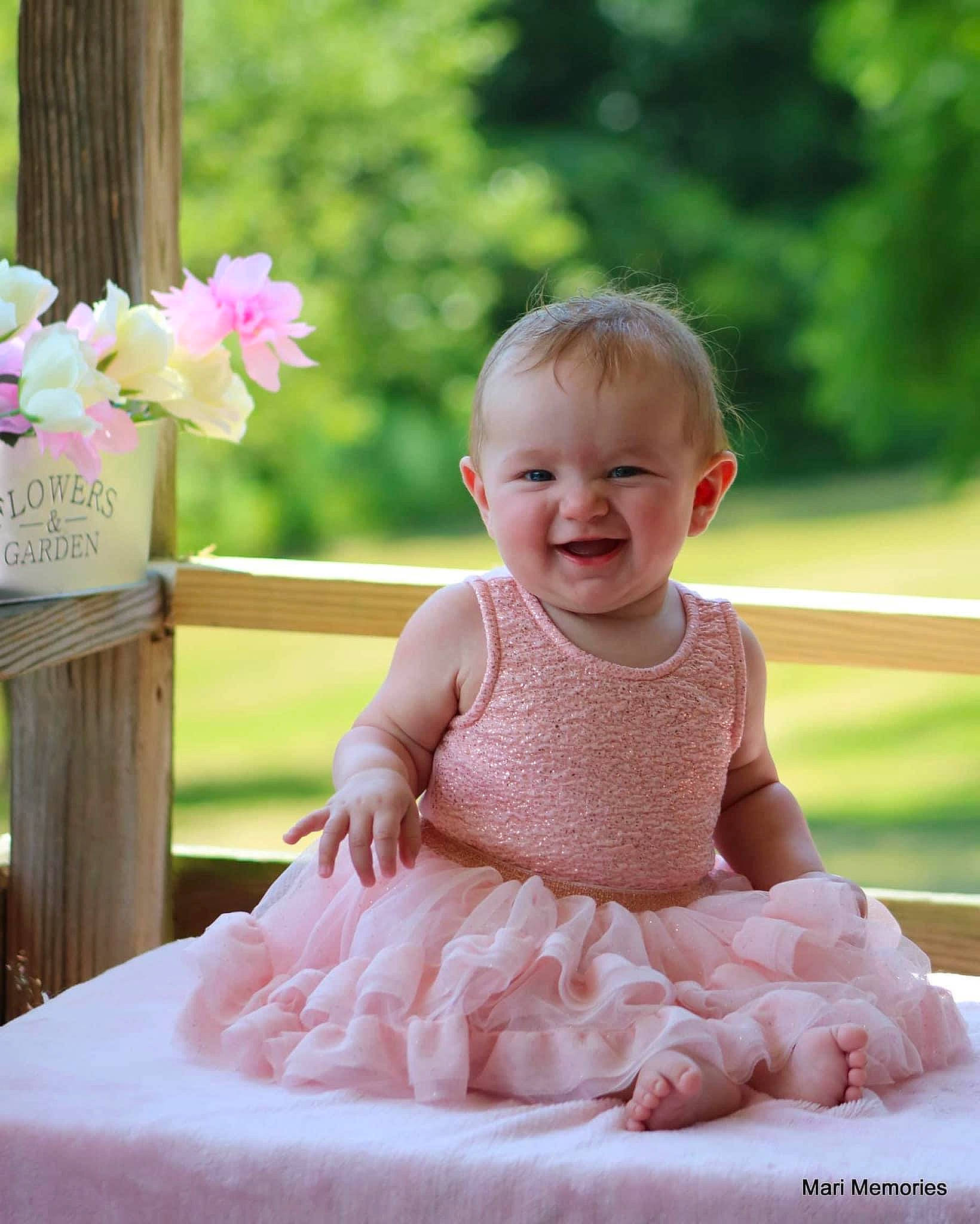 Rosalynn is registered to the contest to win money with this photo: baby, baby_toddler_clothing, birthday, child, dress, family, happy, joy, people, person, photograph, pink, product, sitting, skin, smile, toddler