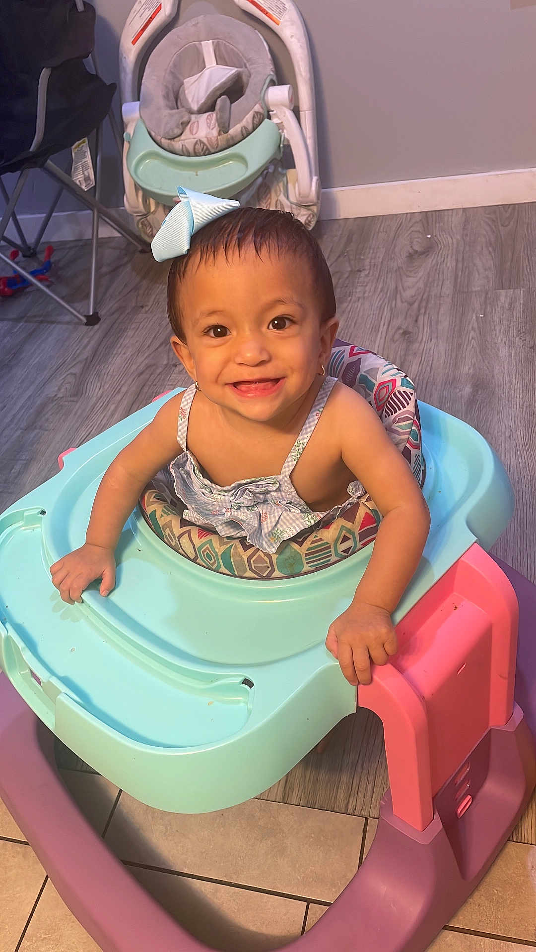 Luismar Leal Palan joined the competition — help win amazing prizes! toddler, baby, smiling, bow, walker, indoor, child, floor, happy, person, clothing, earrings, wood_floor, toy, seat, pink, blue, pastel_colors, cute, portrait