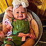 baby, infant, smiling, headband, bow, green_overalls, pink_bow, blanket, basket, wooden_background, cute, child, portrait, happy, indoor, soft_texture, comfortable, clothing, person, skin