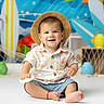 Enzo joined the competition — help win amazing prizes! toddler, child, hat, smile, sitting, toy, shirt, shorts, barefoot, indoor, colorful, background, surfboard, lantern, net, playful, happy, portrait, cute, summer
