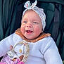 baby, child, smiling, headband, knit_sweater, pacifier, toy, stroller, happy, cute, infant, outdoor, warm_clothing, face, portrait, person, cozy, colorful, pink, white